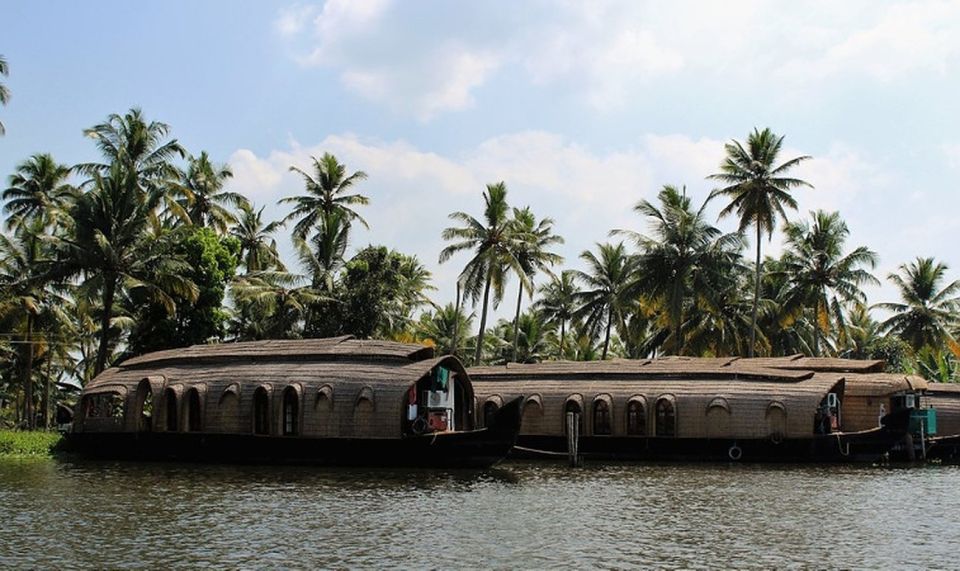 Cochin: Alleppey Backwater Private Day Cruise by Houseboat - Boarding a traditional wooden houseboat with three crew members