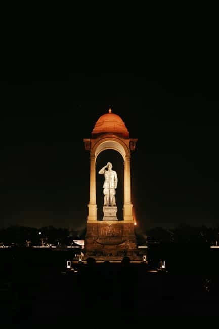 Delhi: Evening City Tour with Private Guide By Car - India Gate after dark: war memorial with real-life evening energy